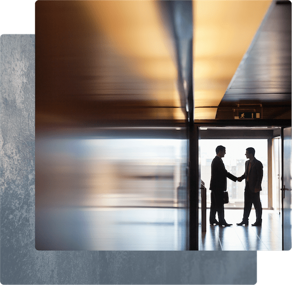 A side-view of an open laptop on a desk with warm lighting.