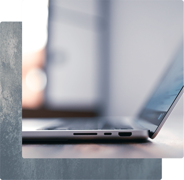 A shallow-focus shot of a laptop computer in a warm, professional setting.
