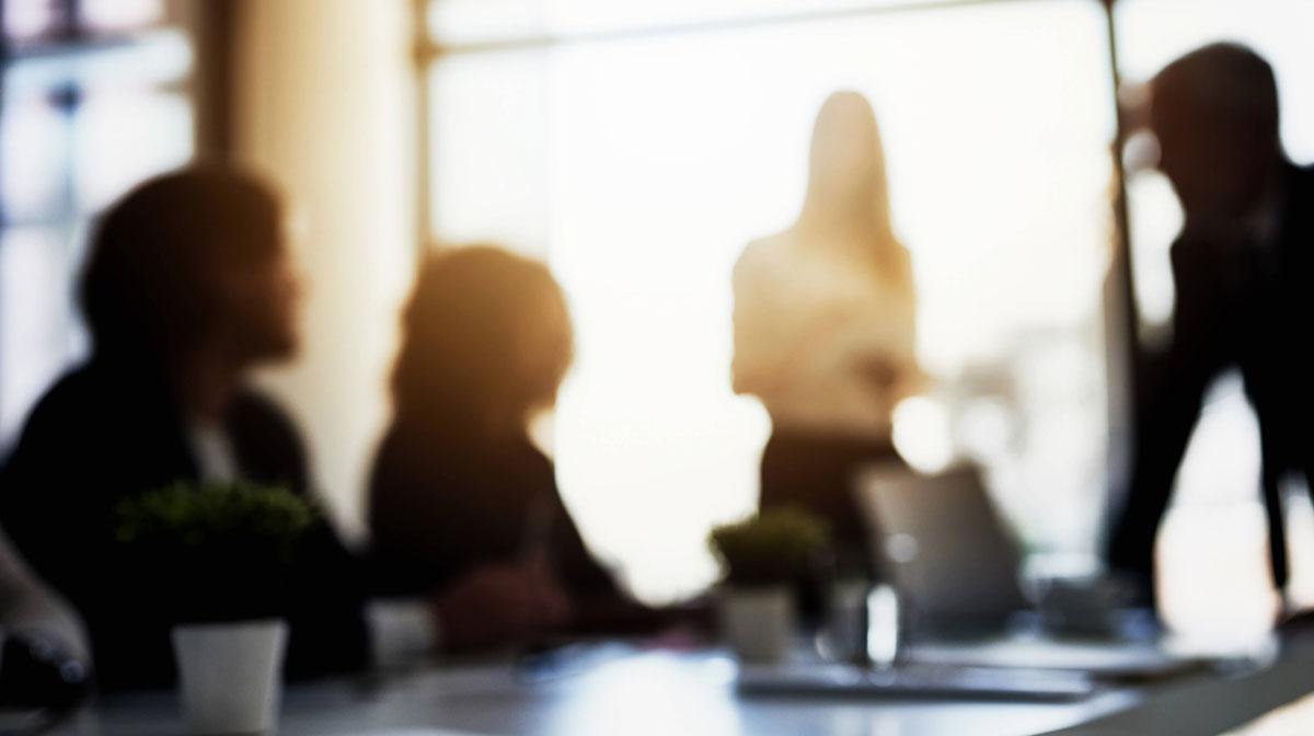 Blurry view of a team meeting in a modern office